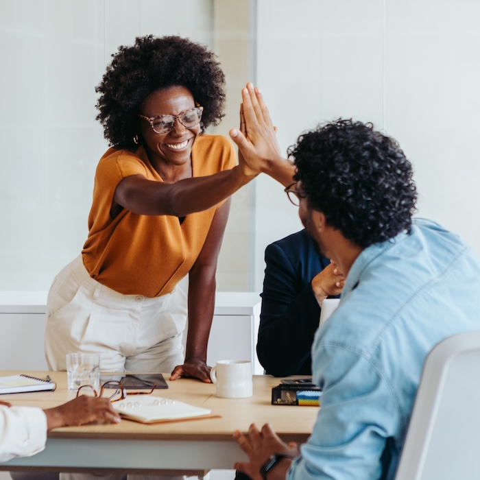 colleagues giving each other a high-five